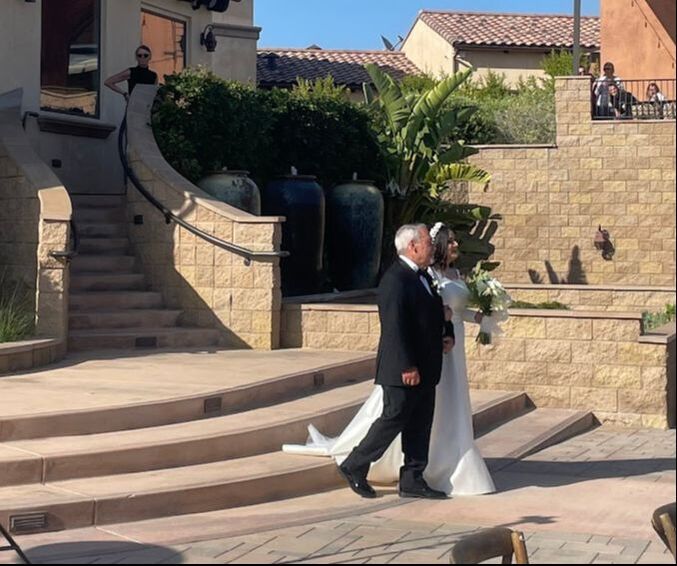 Picture of father walking his daughter down the aisle at Fazeli Cellars Winery